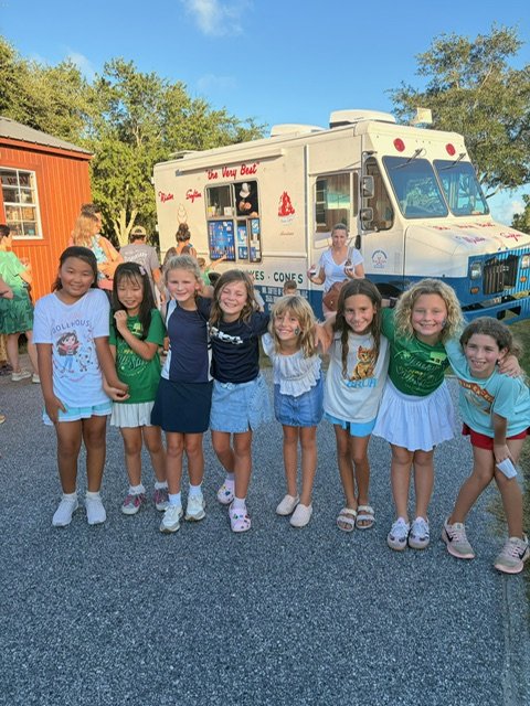 A group of MPA students posing in front of the Mister Softee ice cream truck