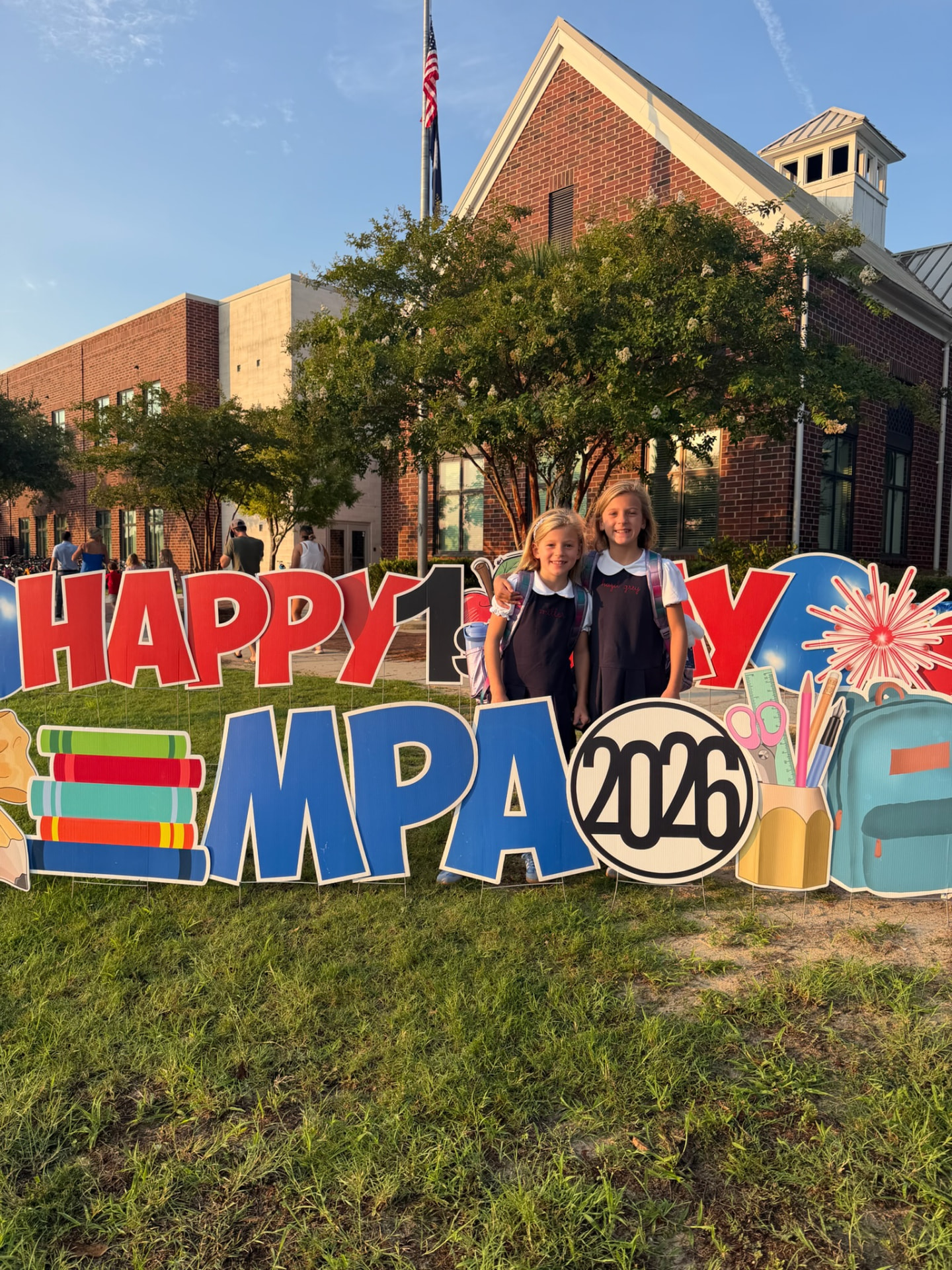Two MPA students hugging in front of the Happy First Day MPA 2026 sign