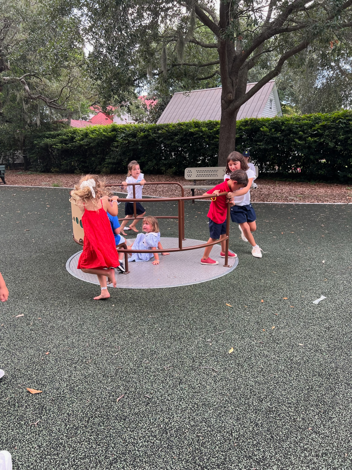 MPA students spinning the playground merry-go-round together