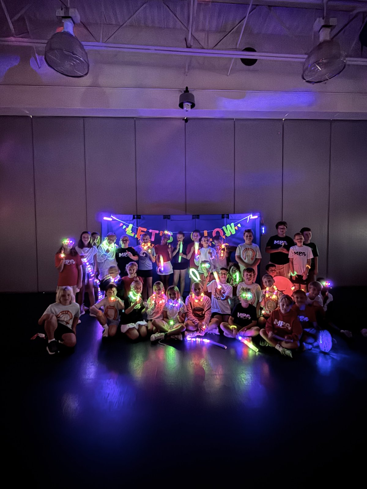 Students glowing in neon at the MPA Glow Party