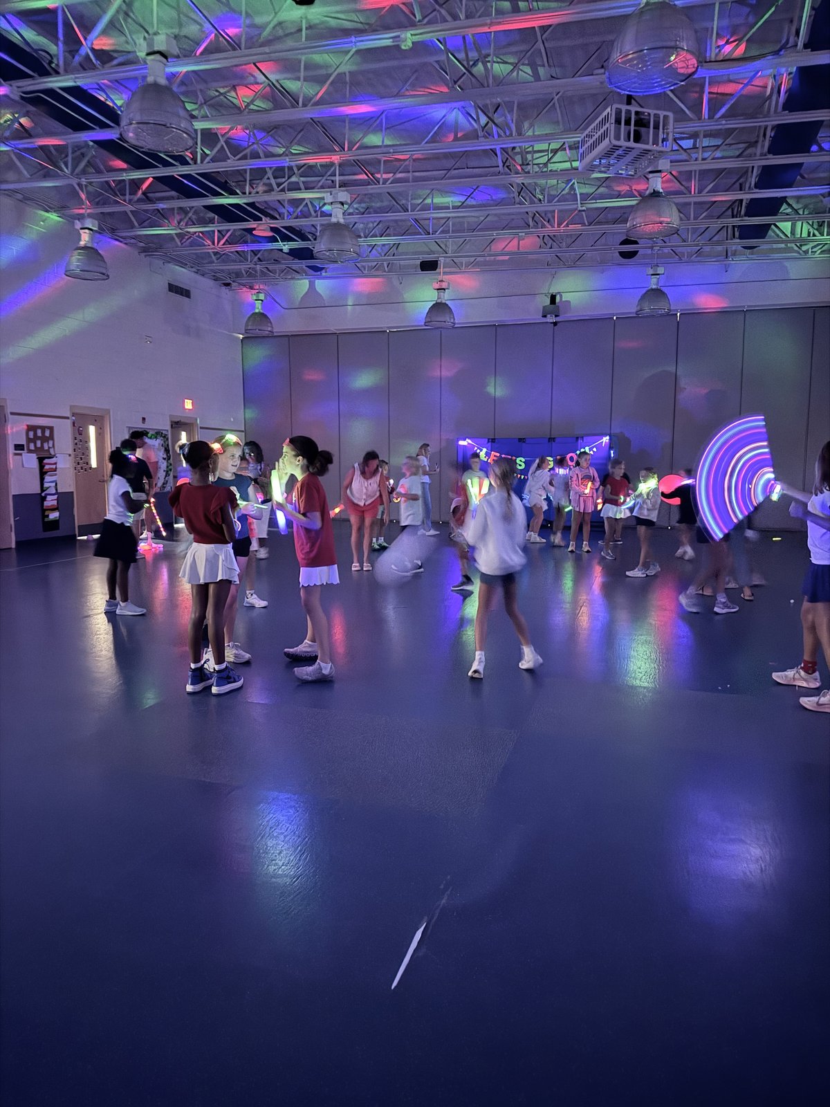 The MPA gym glowing with neon lights during the Glow Party