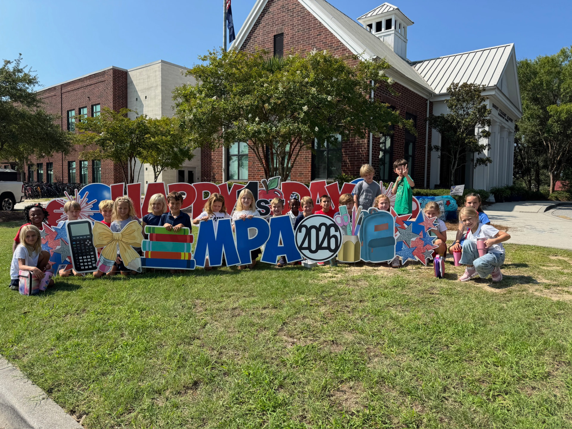 A class of MPA students posing together behind the Happy First Day MPA 2026 sign