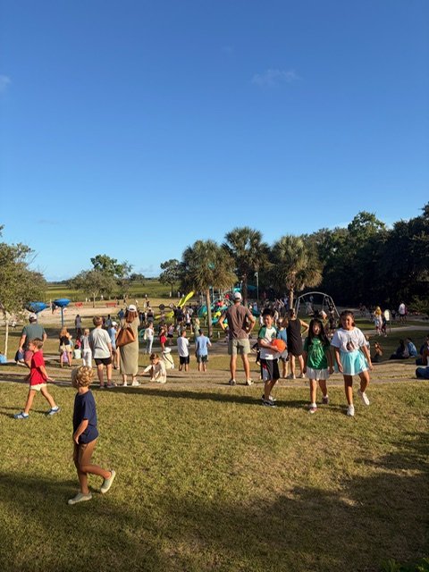 MPA students playing on the school field under a blue sky at Party on the Playground